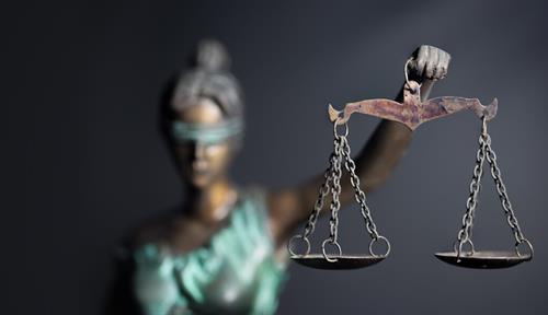 Photograph of a statue of Lady Justice, shown blindfolded and holding a balance scale.